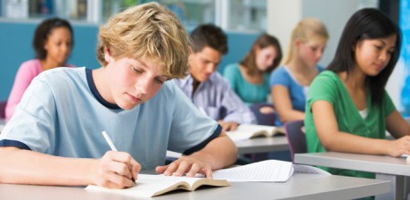 Schoolboy working in high school class